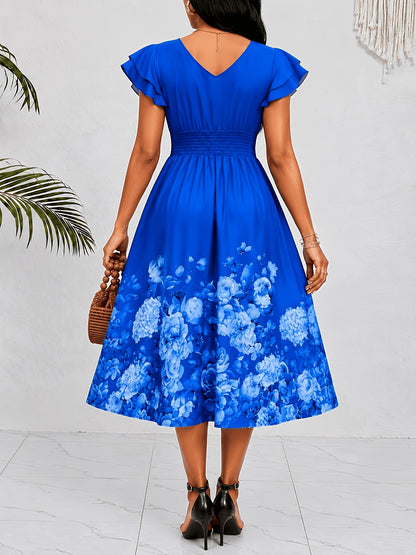 Mediterranean Style Royal Blue Floral Printed Dress with Flutter Sleeves, V-Neck, Cinched Waist, And a Flowing Skirt Perfect for Vacations