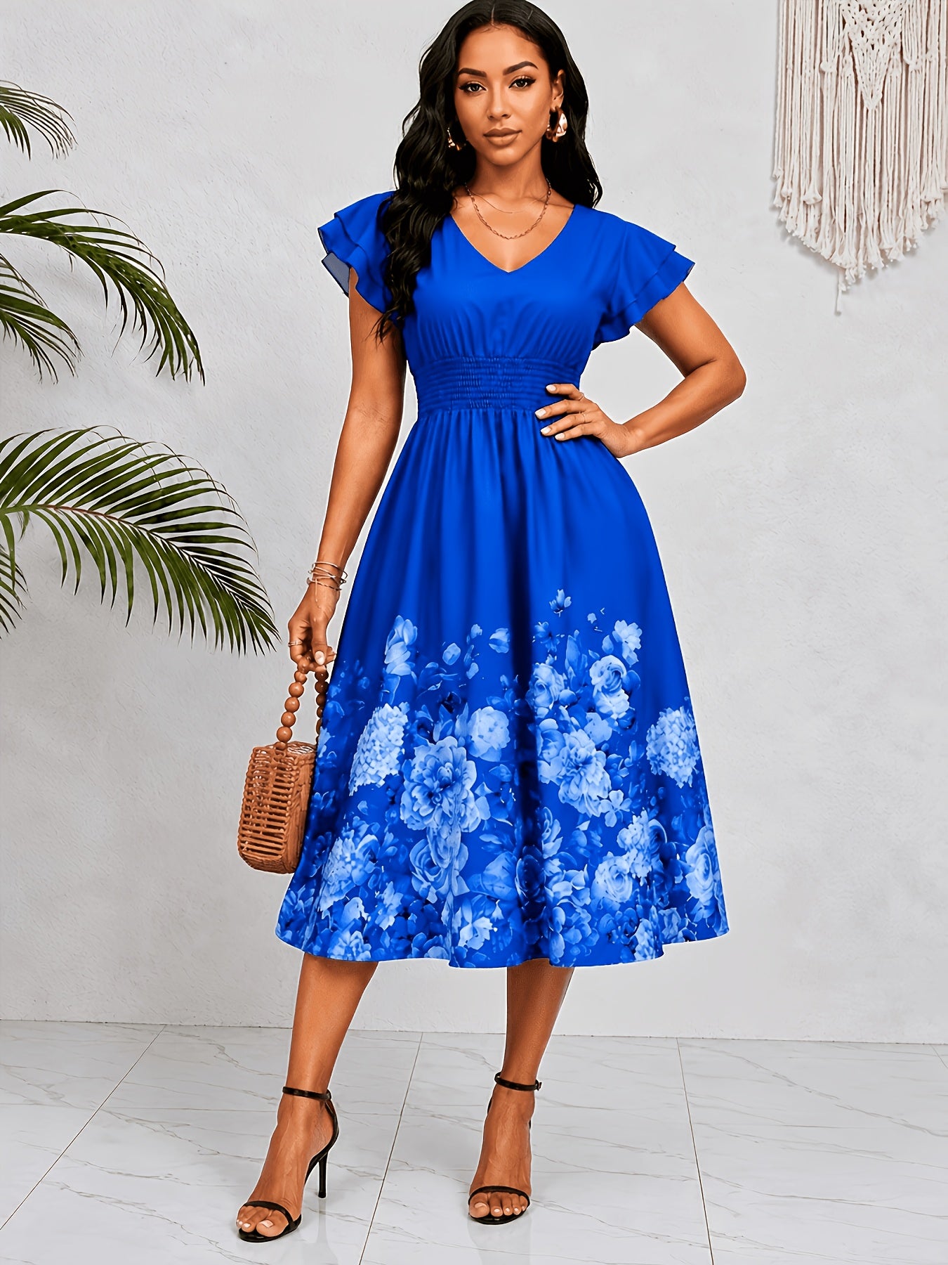 Mediterranean Style Royal Blue Floral Printed Dress with Flutter Sleeves, V-Neck, Cinched Waist, And a Flowing Skirt Perfect for Vacations
