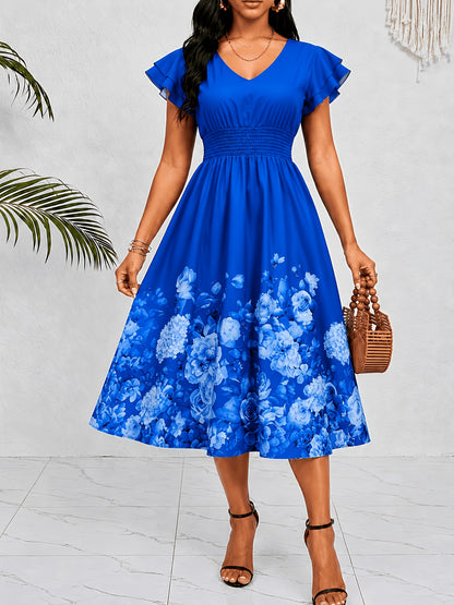 Mediterranean Style Royal Blue Floral Printed Dress with Flutter Sleeves, V-Neck, Cinched Waist, And a Flowing Skirt Perfect for Vacations