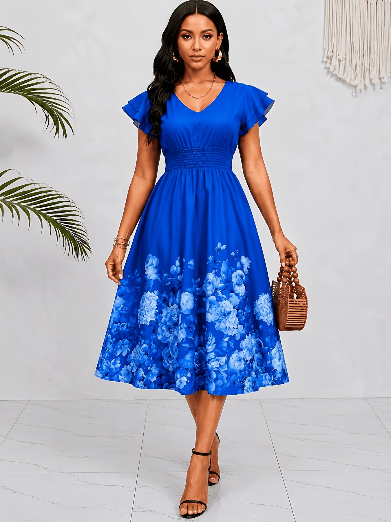 Mediterranean Style Royal Blue Floral Printed Dress with Flutter Sleeves, V-Neck, Cinched Waist, And a Flowing Skirt Perfect for Vacations